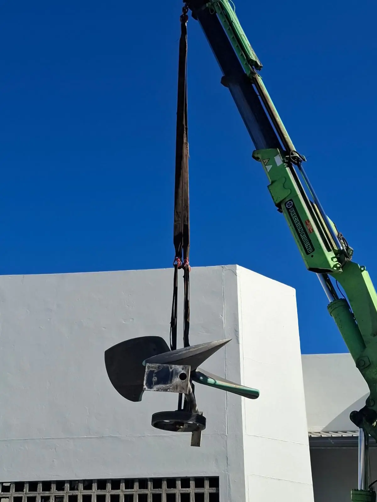 Team lowering air conditioning unit into residential home for installation